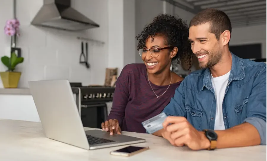 A happy couple shopping online with AllGives